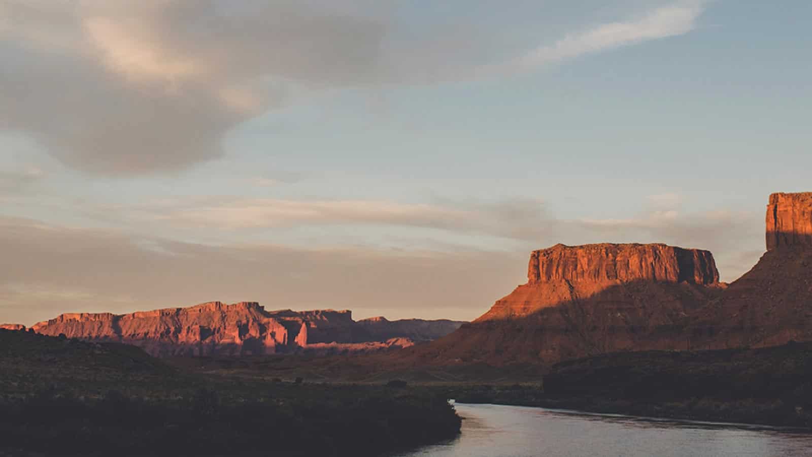 Landscape view of a river and mountains with a sunset