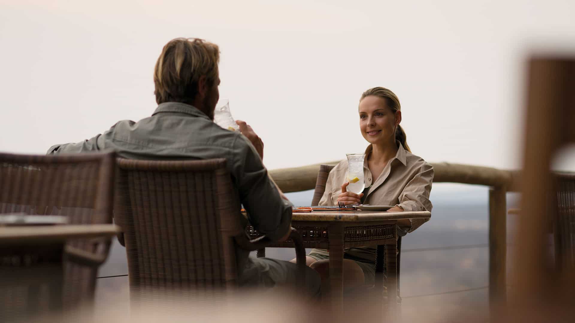 Two people sipping drinks