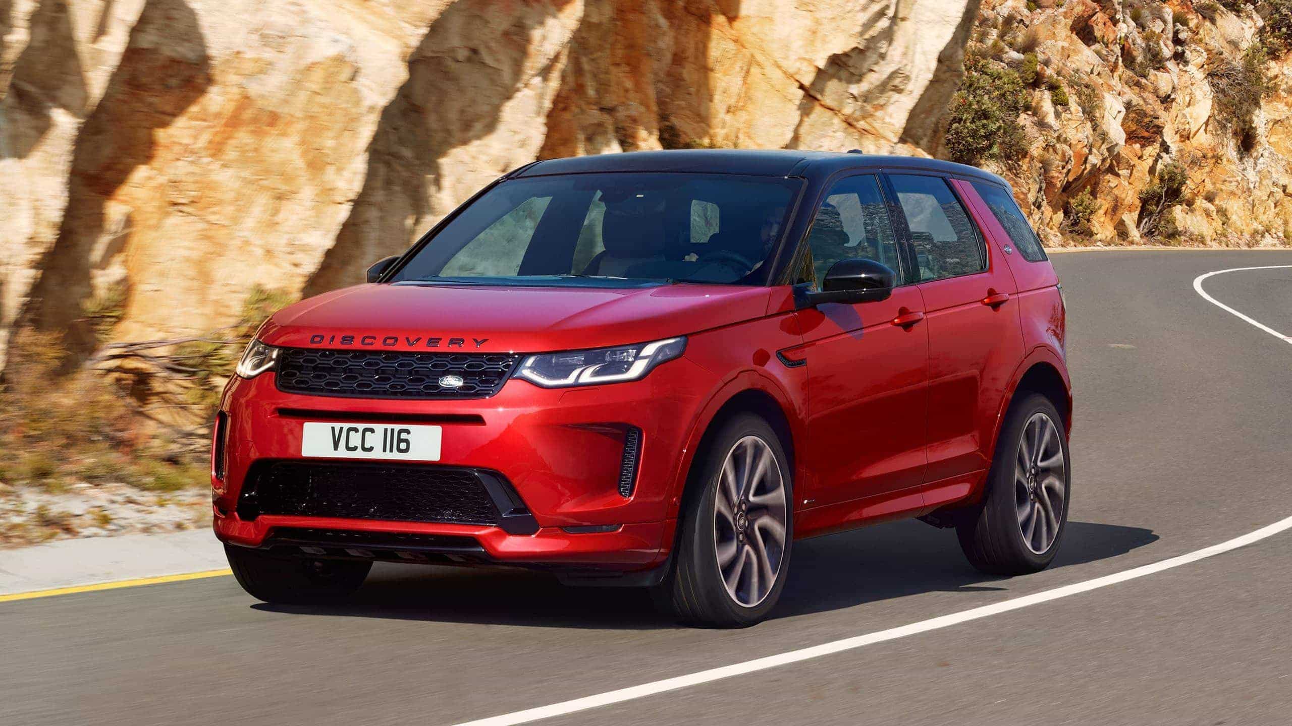 Range Rover Discovery Sport in Red driving on road