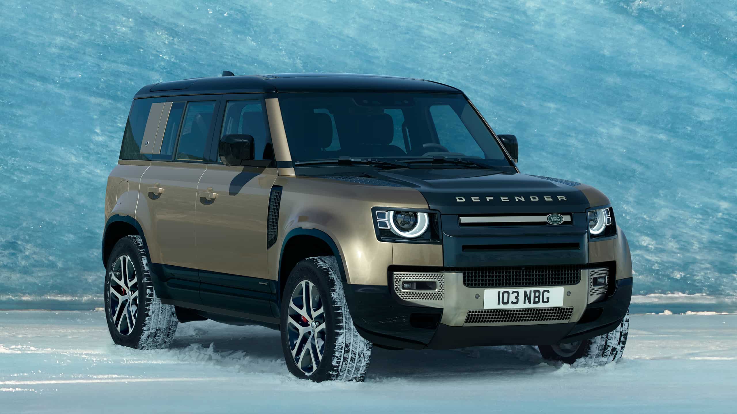 Defender 110 parked in front of ice wall