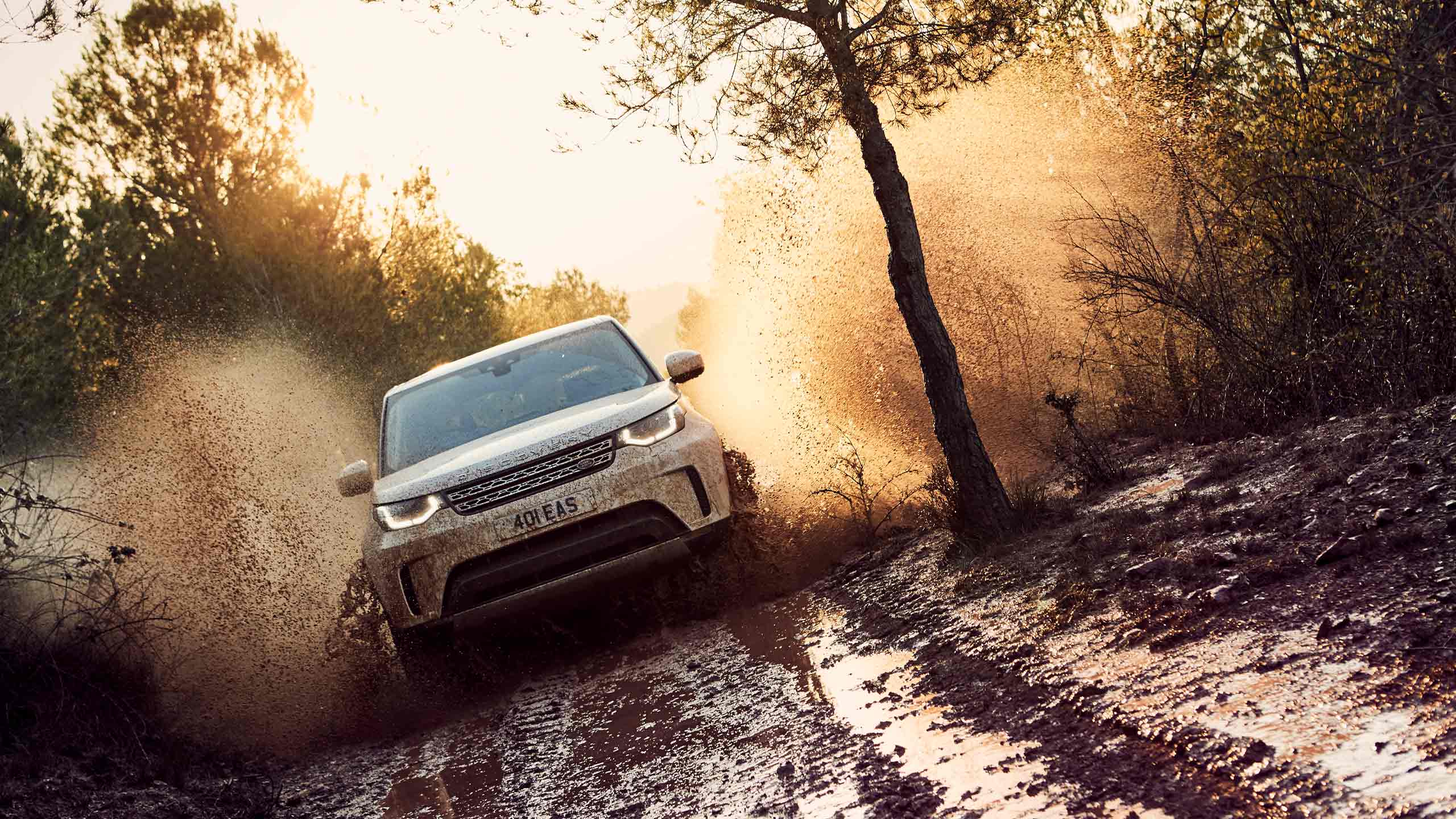 Range Rover drive crosses the mud obstacle on the forest off-road