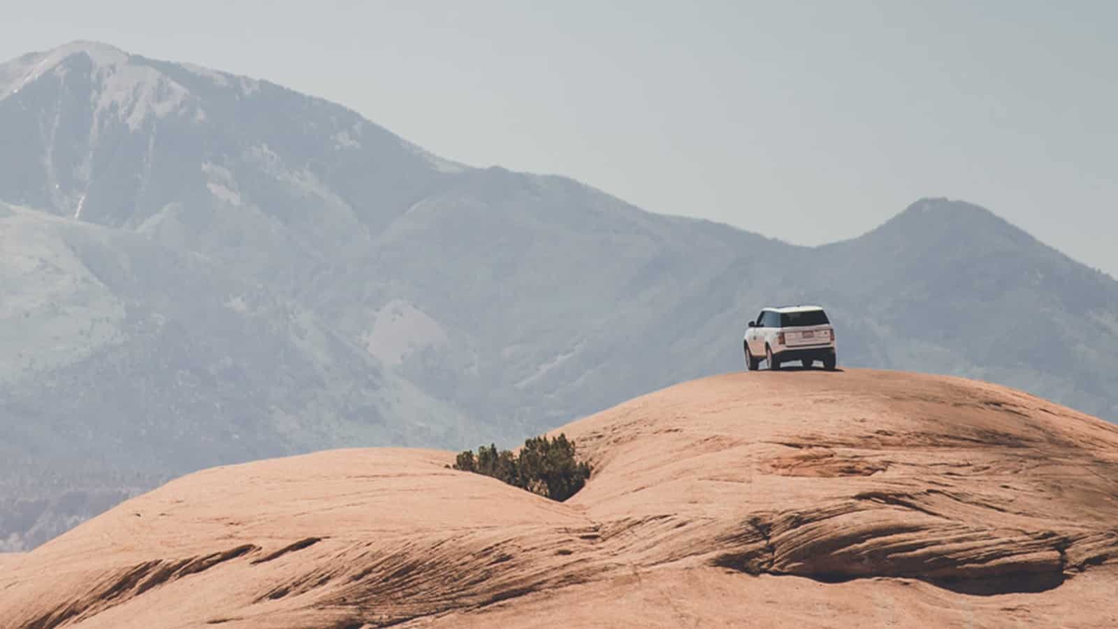 Range Rover parked on a rock 